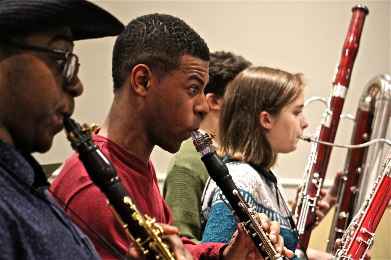 Marquise Bradley, a founding member of the Center City Chamber Orchestra, plays during rehearsal at Settlement Music School. (Emma Lee/WHYY)