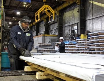 Workers prepare steel for shipment at Camden Yards Steel Company. (Emma Lee/WHYY)