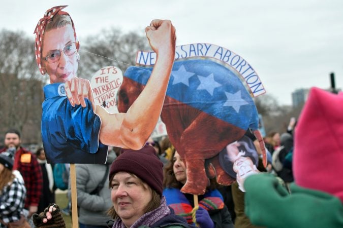 Creative signs are held up by participants during the 2019 Women's March, at Eakins Oval, in Philadelphia, Pa. (Bastiaan Slabbers for WHYY)