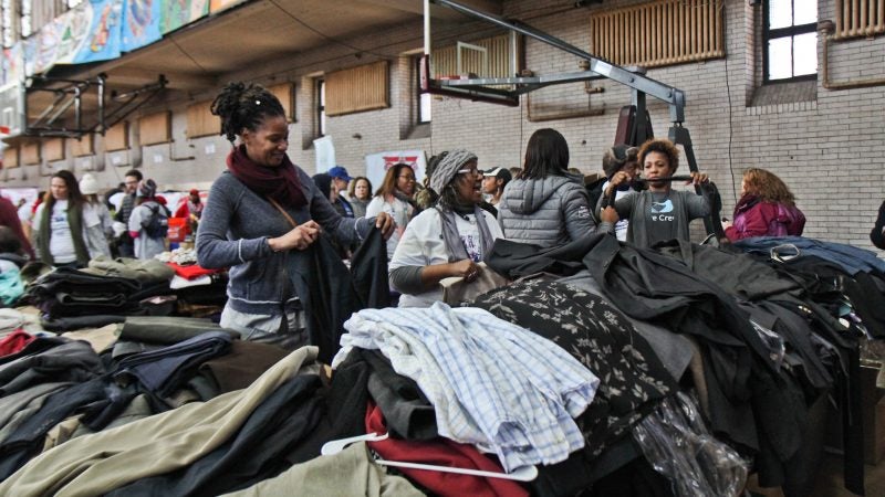 Volunteers organize professional clothing for at the MLK Day of Service at Girard College. (Kimberly Paynter/WHYY)