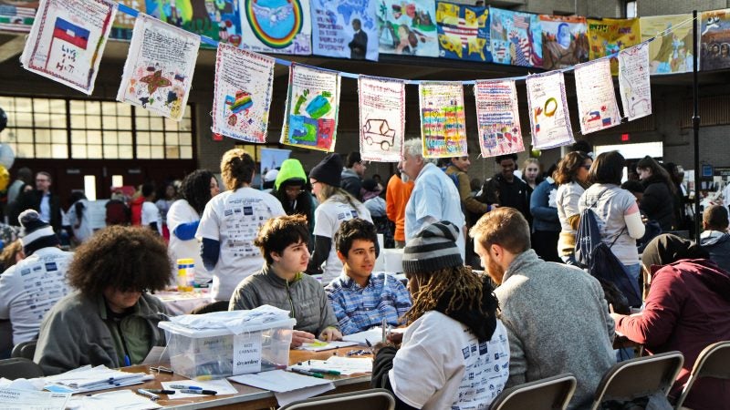 Participants at the MLK Day of Service at Girard College create banners. (Kimberly Paynter/WHYY)