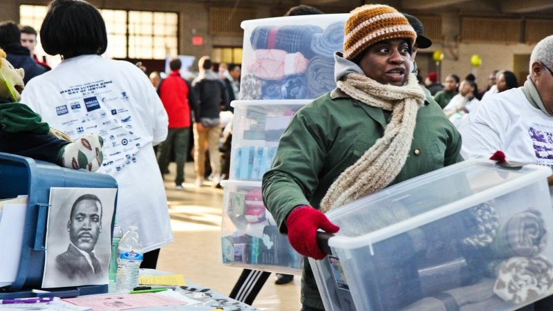 Participants collect blankets  at the MLK Day of Service at Girard College. (Kimberly Paynter/WHYY)