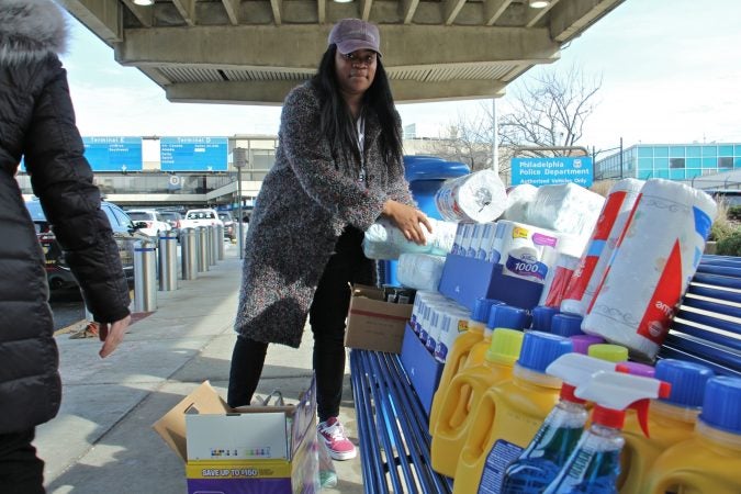 Alora Miller unloads donated supplies at Philadelphia International Airport for TSA employees who continue to work during the government shutdown but are not getting paid. (Emma Lee/WHYY)