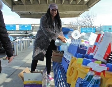 Alora Miller unloads donated supplies at Philadelphia International Airport for TSA employees who continue to work during the government shutdown but are not getting paid. (Emma Lee/WHYY)