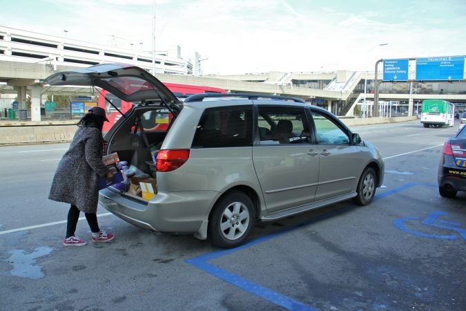 Alora Miller unloads donated supplies at Philadelphia International Airport for TSA employees who continue to work during the government shutdown but are not getting paid. (Emma Lee/WHYY)