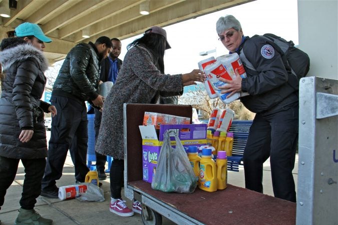 TSA employees collect donated supplies from Alora Miller at Philadelphia International Airport. (Emma Lee/WHYY