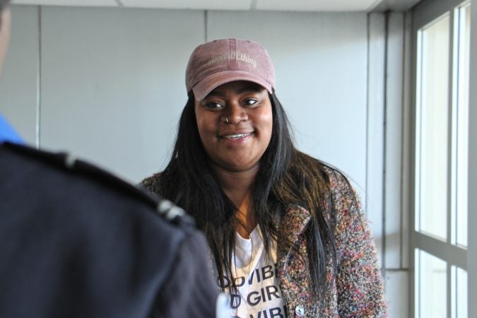 Alora Miller talks with TSA employee Lashanda Palmer after delivering a load of supplies for federal workers who have to work during the government shutdown, but aren't being paid. (Emma Lee/WHYY)