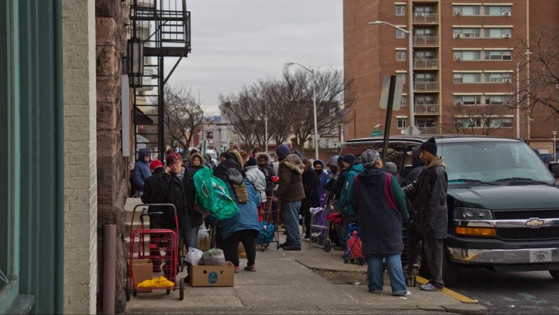 Residents of Reading, Pennsylvania wait in line at the St. James Chapel Church food bank. Four in ten households in Reading receive SNAP benefits. (Kimberly Paynter/WHYY)