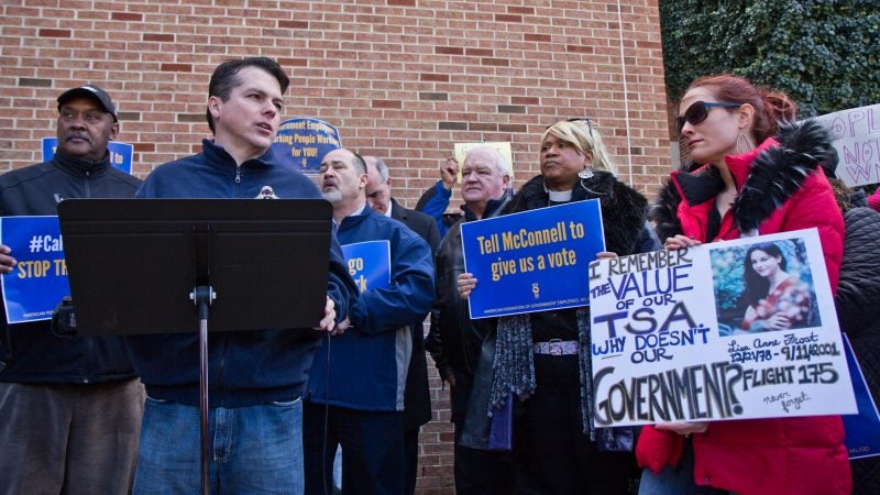 U.S. Congressman Brendan Boyle calls for an end to government shutdown outside Philadelphia International airport Friday. (Kimberly Paynter/WHYY)