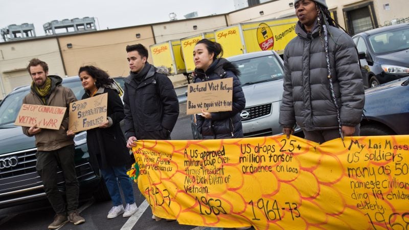Members and supporters of Philadelphia’s Southeastern Asian community carry a history dragon to protest deportations at a shopping center on West Oregon Avenue on Sunday, Jan. 27, 2019. (Kimberly Paynter/WHYY)