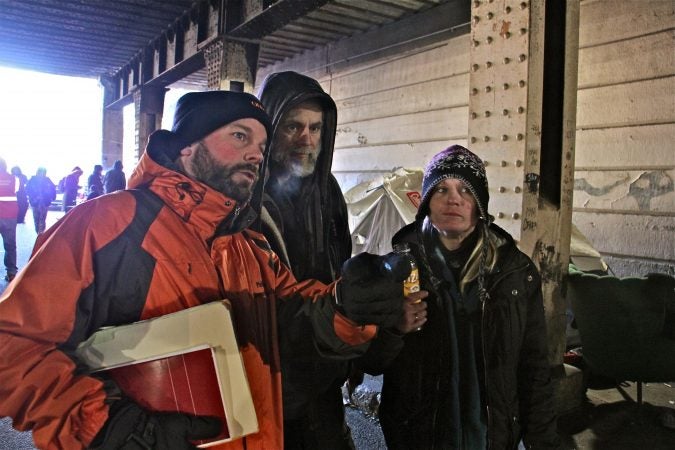 Department of Behavioral Health Homeless Services Director Tim Sheahan guides encampment residents who had made plans prior to the Emerald Street clear out. (Emma Lee/WHYY)