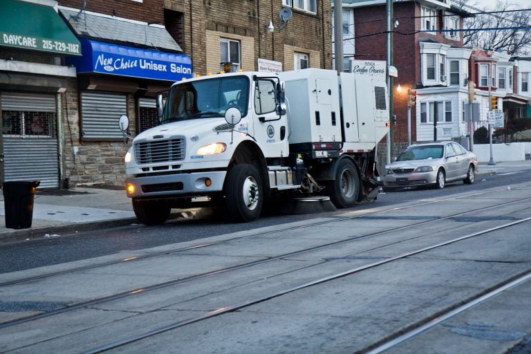 A city street sweeper cleans Chester Avenue in Southwest Philadelphia. (Kimberly Paynter/WHYY)