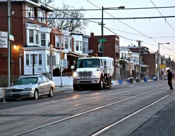 A city street sweeper cleans Chester Avenue in Southwest Philadelphia on Jan. 3, 2019. (Kimberly Paynter/WHYY)