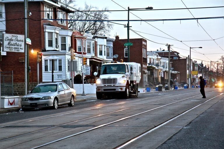 A city street sweeper cleans Chester Avenue in Southwest Philadelphia on Jan. 3, 2019. (Kimberly Paynter/WHYY)