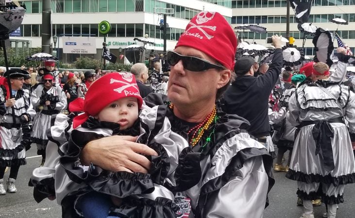 Fran Masino takes his son Remington out for his first march in the Mummers Parade (Tom MacDonald/WHYY)