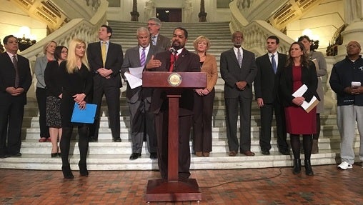 A bipartisan group of lawmakers and others announces a new bill aimed at reforming Pennsylvania's probation and parole systems. (Katie Meyer/WITF)