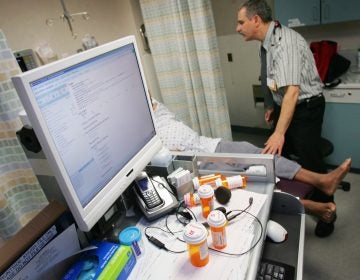 In this Feb. 23, 2010 photo, Dr. Jacob Khushigian checks on a patient who had overdosed with his portable computer data base shown in a Kaweah Delta Emergency Room in Visalia, Calif. (Gary Kazanjian/AP Photo)