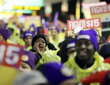 In this file photo, a woman shouts while marching with service workers asking for $15 minimum wage pay during a rally at Newark Liberty International Airport, Tuesday, Nov. 29, 2016, in Newark, N.J. (Julio Cortez/AP Photo)