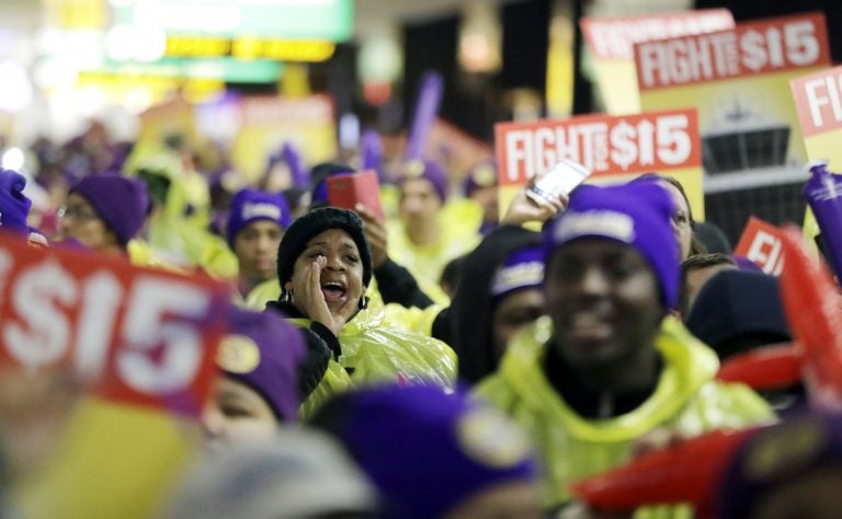 In this file photo, a woman shouts while marching with service workers asking for $15 minimum wage pay during a rally at Newark Liberty International Airport, Tuesday, Nov. 29, 2016, in Newark, N.J. (Julio Cortez/AP Photo)