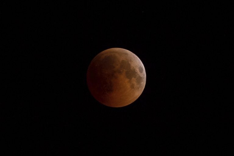 In this July 27 2018 file photo, Earth starts to cast its shadow on the moon during a total lunar eclipse seen from Volgograd, Russia. Starting Sunday evening, Jan. 20, 2019, all of North and South America will be able to see the only total lunar eclipse of 2019 from start to finish this weekend. (Aleksandr Kulikov/Kommersant/Sipa USA (Sipa via AP Images))