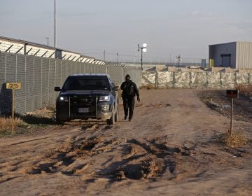 In this file photo, a private security guard patrols outside the Tornillo detention camp for migrants in Tornillo, Texas, Thursday Dec. 13, 2018. (Andres Leighton/AP Photo)