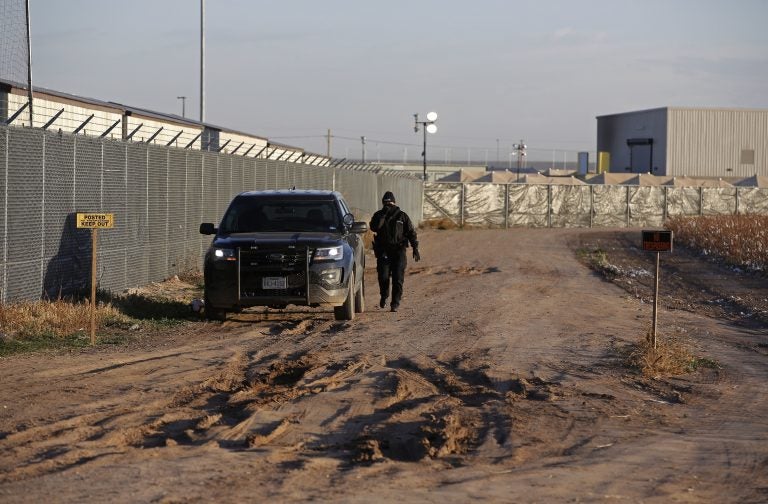 In this file photo, a private security guard patrols outside the Tornillo detention camp for migrants in Tornillo, Texas, Thursday Dec. 13, 2018. (Andres Leighton/AP Photo)