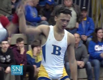 In this image taken from a Wednesday, Dec. 19, 2018 video provided by SNJTODAY.COM, Buena Regional High School wrestler Andrew Johnson is declared the winner after his match in in Buena, N.J. Before the match a referee told Johnson he would forfeit his bout if he didn't have his dreadlocks cut off. Johnson had his hair cut minutes before the match and a SNJ Today reporter tweeted video of the incident. The state's Interscholastic Athletic Association says they are recommending the referee not be assigned to any event until the matter has been reviewed more thoroughly. (Michael Frankel/SNJTODAY.COM viavAP)