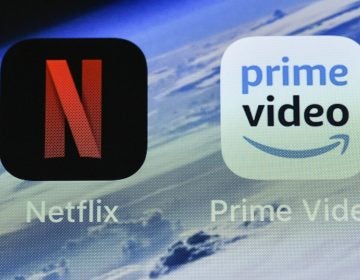 In this Thursday, Nov. 15, 2018 file photo, the icons of streaming services Netflix and AmazonPrime Video are pictured on an iPhone in Gelsenkirchen, Germany. Streaming your favorite movies and TV shows is about to get way more expensive. Amazon Prime customers can add-on subscriptions to HBO, Showtime or Starz. (Martin Meissner/AP Photo, File)