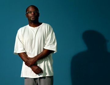 In this Thursday, July 10, 2014 photo, Bobby Bostic stands for a portrait in the visitation room at the Crossroads Correctional Center in Cameron, Mo., where he has served 23 years of a 241-year sentence for a 1995 robbery. At the age of 16, Bostic and a friend held up some people delivering some donated Christmas gifts to a needy St. Louis family. Bostic fired a shot that grazed one man. (Robert Cohen/St. Louis Post-Dispatch via AP)