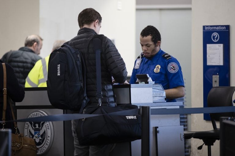 A Transportation Security Administration official works at the entrance to a gate at the Philadelphia International Airport in Philadelphia, Friday, Jan. 11, 2019. (AP Photo/Matt Rourke)