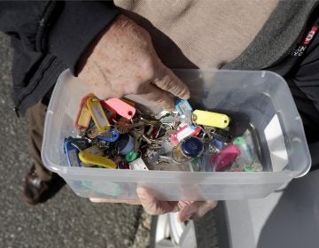 In a photo taken Friday, Jan. 11, 2019, Vince Farias looks through a container with keys to his rental properties in Surf City, N.J. (Julio Cortez/AP Photo)