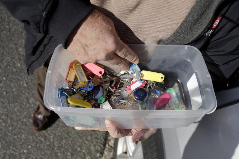 In a photo taken Friday, Jan. 11, 2019, Vince Farias looks through a container with keys to his rental properties in Surf City, N.J. (Julio Cortez/AP Photo)