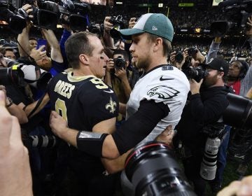 New Orleans Saints quarterback Drew Brees (9) speaks with Philadelphia Eagles quarterback Nick Foles after an NFL divisional playoff football game in New Orleans, Sunday, Jan. 13, 2019. The Saints won 20-14 to advance to the NFC Championship. (AP Photo/Bill Feig)