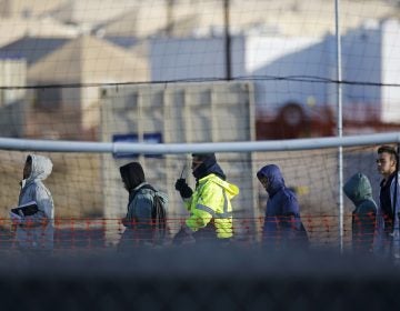 In this Dec. 13, 2018, file photo, teen migrants walk in line inside the Tornillo detention camp in Tornillo, Texas. Government investigators say many more migrant children may have been separated from their parents than the Trump administration has acknowledged.  (Andres Leighton/AP)