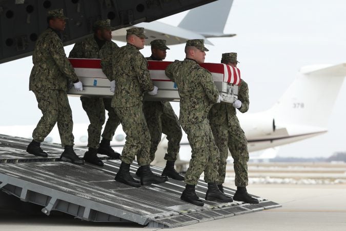 A U.S. Navy carry team moves a transfer case containing the remains of Scott A. Wirtz, Saturday, Jan. 19, 2019, at Dover Air Force Base, Del. According to the Department of Defense, Wirtz, a civilian and former Navy SEAL from St. Louis, Mo., was killed Jan. 16, 2019, in a suicide bomb attack in Manbij, Syria. President Donald Trump attend the return ceremony. (Andrew Harnik/AP Photo)