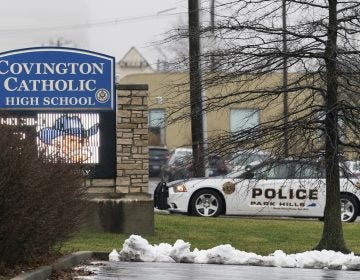 A police car sits at the entrance to Covington Catholic High School in Park Hills, Ky., Saturday, Jan 19, 2019. A diocese in Kentucky apologized Saturday after videos emerged showing students from the Catholic boys' high school mocking Native Americans outside the Lincoln Memorial on Friday after a rally in Washington. (AP Photo/Bryan Woolston)