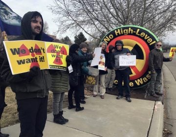 In this Tuesday, Jan. 22, 2019 photo, Brendan Shaughnessy, (left), with the Nuclear Issues Study Group, protests with other activists ahead of a meeting of a U.S. Nuclear Regulatory Commission panel in Albuquerque, N.M. (Susan Montoya Bryan/AP Photo)