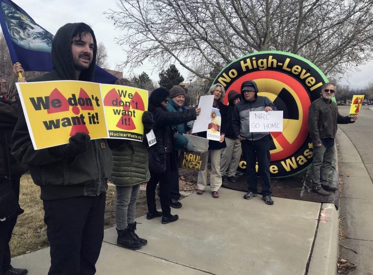 In this Tuesday, Jan. 22, 2019 photo, Brendan Shaughnessy, (left), with the Nuclear Issues Study Group, protests with other activists ahead of a meeting of a U.S. Nuclear Regulatory Commission panel in Albuquerque, N.M. (Susan Montoya Bryan/AP Photo)