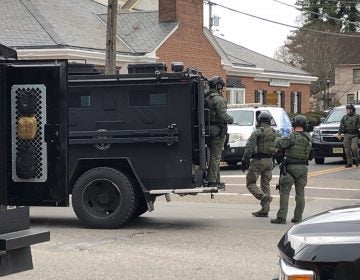 A police SWAT team arrives at the site of a standoff between law enforcement and a fugitive they were trying to arrest, Wednesday, Jan. 23, 2019 in Salem, N.J. New Jersey State Police and other law enforcement agencies responded to Salem after reports that shots were fired during the standoff. (Geoff Mulvihill/AP Photo)