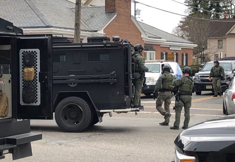 A police SWAT team arrives at the site of a standoff between law enforcement and a fugitive they were trying to arrest, Wednesday, Jan. 23, 2019 in Salem, N.J. New Jersey State Police and other law enforcement agencies responded to Salem after reports that shots were fired during the standoff. (Geoff Mulvihill/AP Photo)