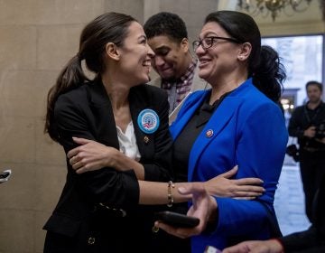 In this Jan. 16, 2019, photo, Rep. Alexandria Ocasio-Cortez, D-N.Y., left, and Rep. Rashida Tlaib, D-Mich., right, laugh as they wait for other freshman Congressmen to deliver a letter calling to an end to the government shutdown to deliver to the office of Senate Majority Leader Mitch McConnell of Ky., on Capitol Hill in Washington. It's known as 
