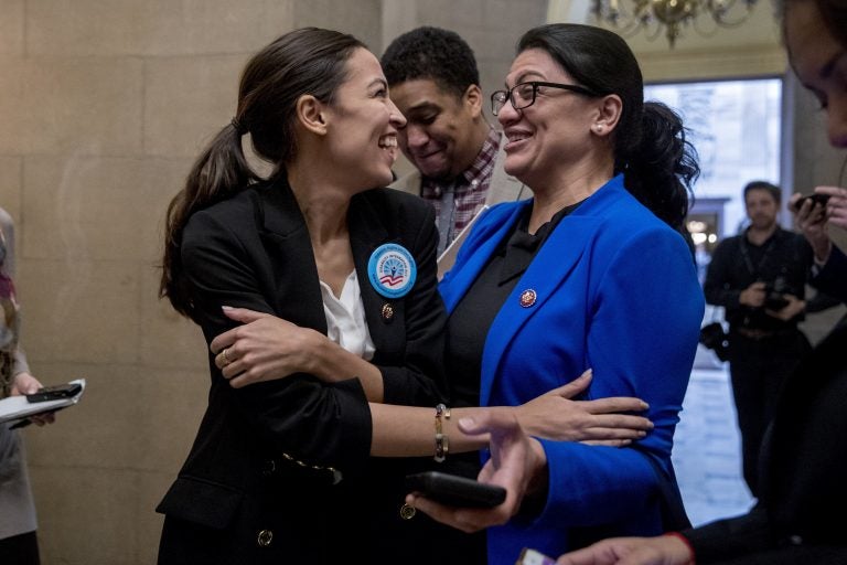 In this Jan. 16, 2019, photo, Rep. Alexandria Ocasio-Cortez, D-N.Y., left, and Rep. Rashida Tlaib, D-Mich., right, laugh as they wait for other freshman Congressmen to deliver a letter calling to an end to the government shutdown to deliver to the office of Senate Majority Leader Mitch McConnell of Ky., on Capitol Hill in Washington. It's known as 