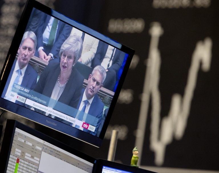 News about the Brexit are seen on a television screen with the curve of the German stock index DAX in background at the stock market in Frankfurt, Germany, Wednesday, Jan. 30, 2019. (Michael Probst/AP Photo)