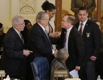 Assembly Speaker Craig Coughlin, second from right, is greeted by colleagues after a vote to raise the minimum wage in Trenton Thursday. Gov. Phil Murphy intends to sign the measure into law Monday. (Seth Wenig/AP Photo)