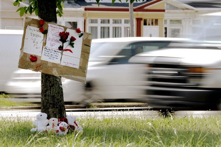 A makeshift memorial is shown near the location where a mother and three young sons were struck and killed while trying to cross a busy highway after dark, Wednesday, July 17, 2013, in Philadelphia.  (Matt Rourke/AP Photo)