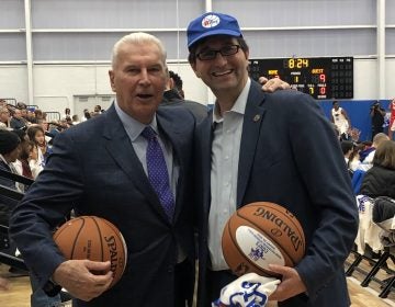 Wilmington Mayor Mike Purzycki (left) and New Castle County Executive Matt Meyer were all smiles Wednesday night at opening night for the Delaware Blue Coats at the city’s new sports and concert facility, but are locked in a dispute over the thorny and expensive issue of property tax reassessment. (Cris Barrish/WHYY)