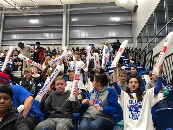 A group of young fans cheers on the Blue Coats during their Wilmington debut Wednesday. (Cris Barrish/WHYY)