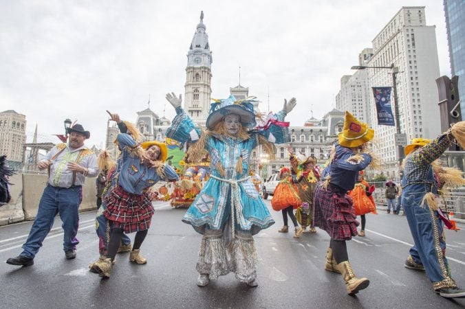 Members of Golden Sunrise rehearse their performance on Market St. prior to the start of the parade. (Jonathan Wilson for WHYY)