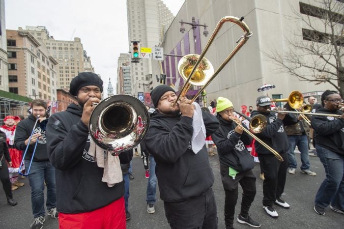 The brass band of the Wench's Cara Liom play Sweet Caroline while brigade members dance. (Jonathan Wilson for WHYY)