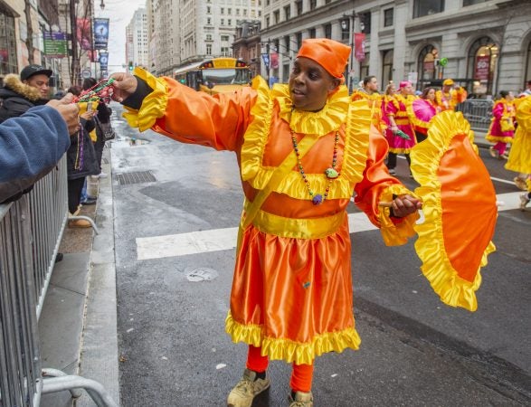 Oregon's Ronnie Hood handed out beads to the crowd as he marched down Broad St. (Jonathan Wilson for WHYY)